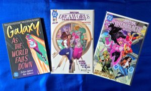The covers of Galaxy: As the World Falls Down graphic novel (cover art by Rye Hickman), Justice League: Dream Girls - A DC Pride Event #1 (cover art by Ted Brandt and Ro Stein), and Justice League Intergalactic Special #1 (cover art by Travis Moore and Tamra Bonvillain)